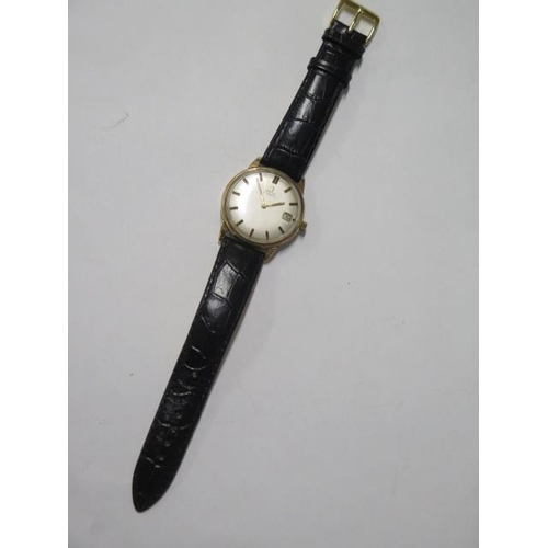 142 - An Omega Automatic gold cased date wristwatch - case 33mm, on a leather strap, in working order, som... 