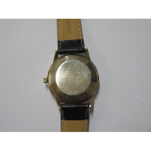 142 - An Omega Automatic gold cased date wristwatch - case 33mm, on a leather strap, in working order, som... 