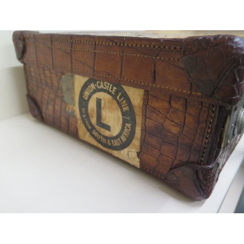 225 - A good early 20th century vintage crocodile suitcase with a fitted green leather interior with two s... 