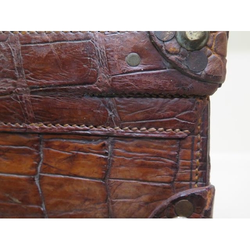 225 - A good early 20th century vintage crocodile suitcase with a fitted green leather interior with two s... 