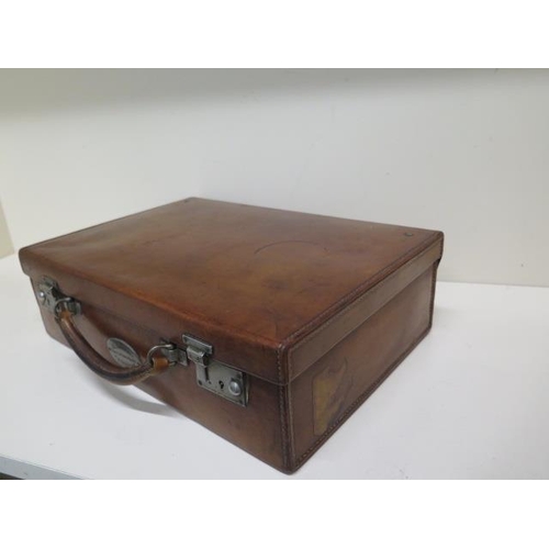 247 - A good quality early 20th century leather attache/travel case by Finnigans Ltd Manchester with a pla... 