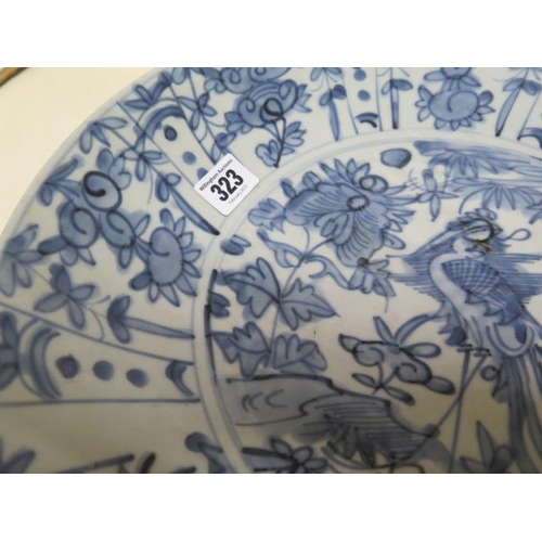 265 - An Oriental blue and white charger bowl decorated with a bird and foliage - Diameter 37cm - good con... 