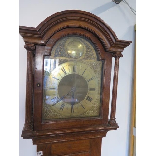 409 - An oak three train chiming longcase clock with a brass arched 12inch dial signed John Simpson, Londo... 