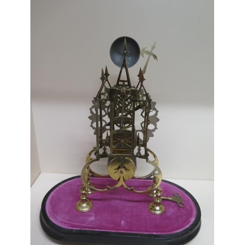411 - A brass Cathedral  skeleton clock with a chain driven fusee movement striking on a bell under a glas... 