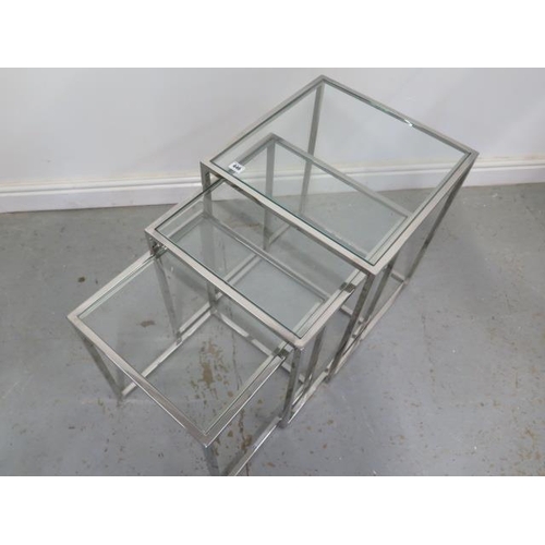 446 - A nest of three chrome and glass side tables - Height 55cm x 45cm x 45cm