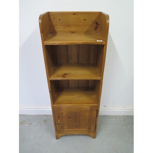 452 - A waxed pine bookcase with cupboard - good colour and polished finish - 109cm x 38cm x 23cm