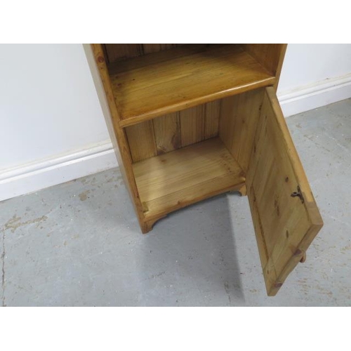 452 - A waxed pine bookcase with cupboard - good colour and polished finish - 109cm x 38cm x 23cm