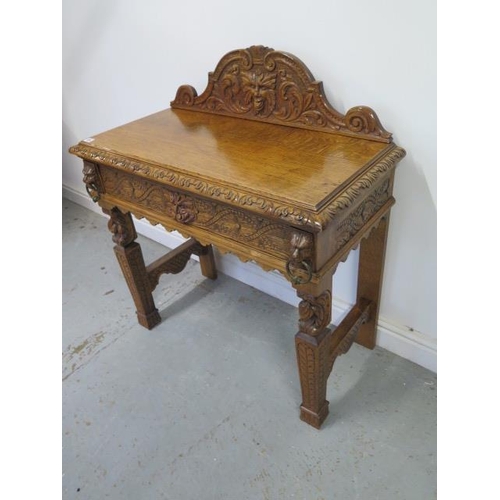 454 - A Green Man carved oak hall/side table with a drawer - with good light colour and polished finish - ... 