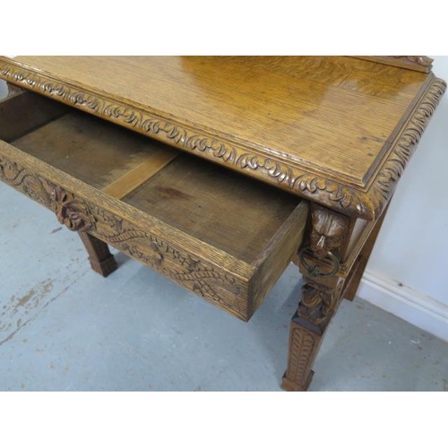454 - A Green Man carved oak hall/side table with a drawer - with good light colour and polished finish - ... 