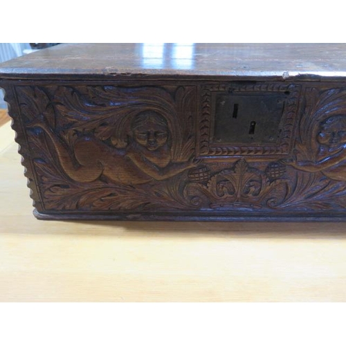 457 - An 18th century oak box with a carved figural and crown front panel - Height 26cm x 79cm x 58cm