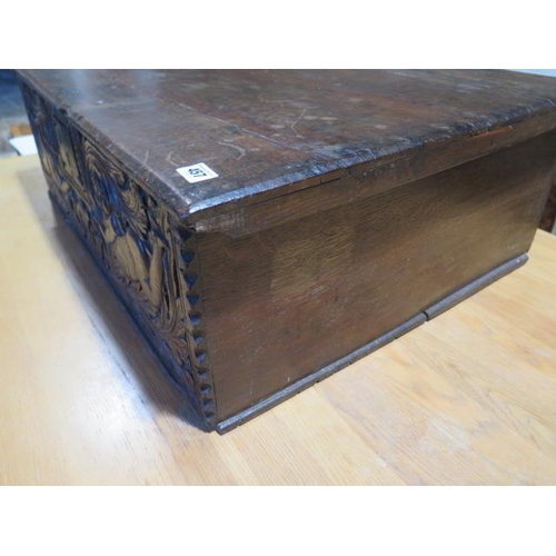 457 - An 18th century oak box with a carved figural and crown front panel - Height 26cm x 79cm x 58cm