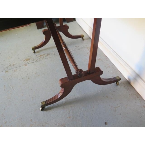 525 - A late 19th century mahogany drop leaf sofa stretcher table with two active and two dummy drawers on... 