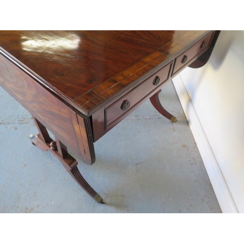 525 - A late 19th century mahogany drop leaf sofa stretcher table with two active and two dummy drawers on... 