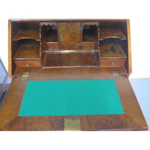 526 - An early 18th century walnut George l bureau with a fitted interior of small drawers and pigeon hole... 