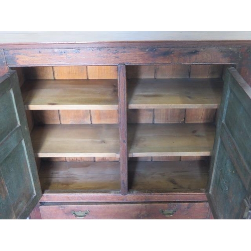 527 - An oak cupboard with two panel doors and a base drawer - Height 95cm x 92cm x 27cm