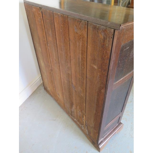 527 - An oak cupboard with two panel doors and a base drawer - Height 95cm x 92cm x 27cm