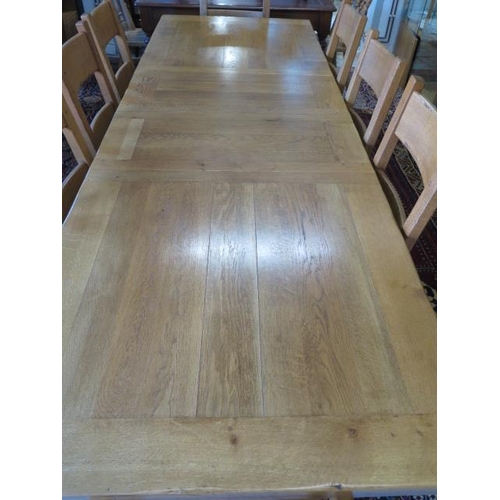 530 - A modern golden oak extending refectory table with two leaves and eight matching solid seat chairs i... 