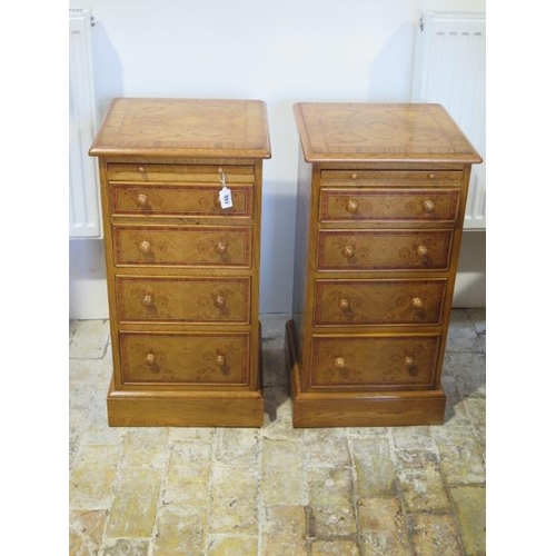 551 - A pair of new burr oak bedside chests with a brushing slide above four graduating drawers - made by ... 