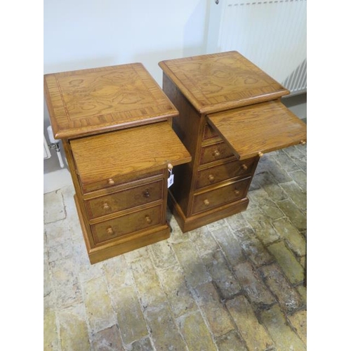 551 - A pair of new burr oak bedside chests with a brushing slide above four graduating drawers - made by ... 