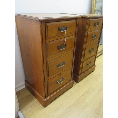 553 - A pair of satin walnut four drawer bedside chests - Height 79cm x 41cm x 37cm - in good polished con... 