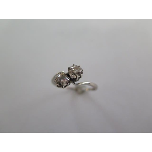 69 - A two stone diamond crossover ring possibly platinum, each diamond approx 0.45ct - one diamond has c... 