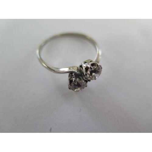 69 - A two stone diamond crossover ring possibly platinum, each diamond approx 0.45ct - one diamond has c... 