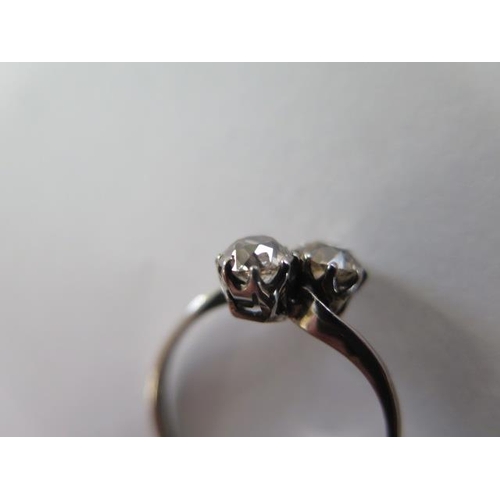 69 - A two stone diamond crossover ring possibly platinum, each diamond approx 0.45ct - one diamond has c... 