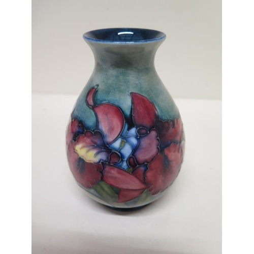 233B - A small Moorcroft vase with label to base - Height 13cm - good condition