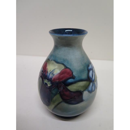 233B - A small Moorcroft vase with label to base - Height 13cm - good condition