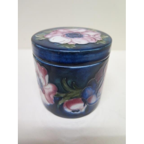 236A - A Moorcroft blue ground lidded pot - Height 8.5cm - some crazing mainly to base, small chips to insi... 