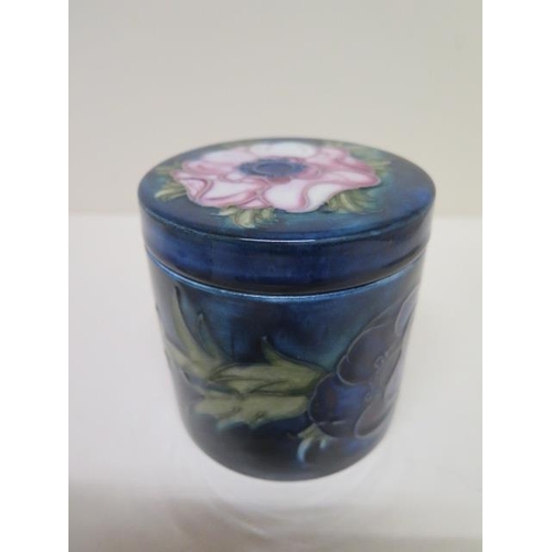 236A - A Moorcroft blue ground lidded pot - Height 8.5cm - some crazing mainly to base, small chips to insi... 