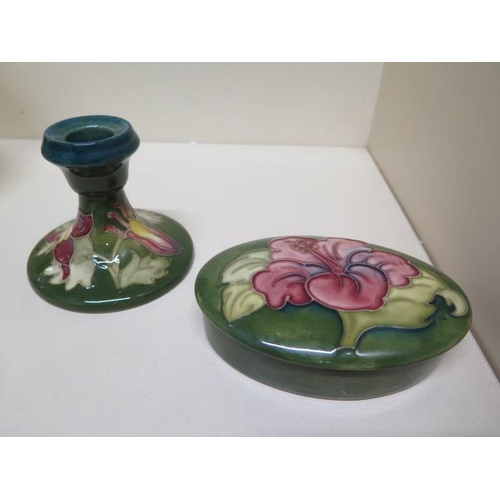 238A - A Moorcroft green ground lidded pot - Width 13cm and a Moorcroft green ground candlestick - Height 8... 