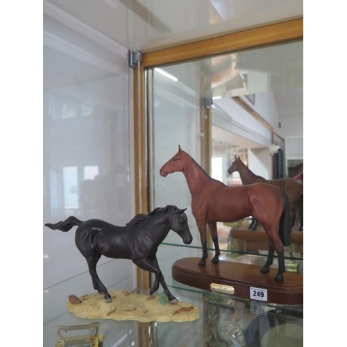 249 - A Royal Doulton brown horse Arkle - Height 31cm and a Royal Doulton black horse - both good