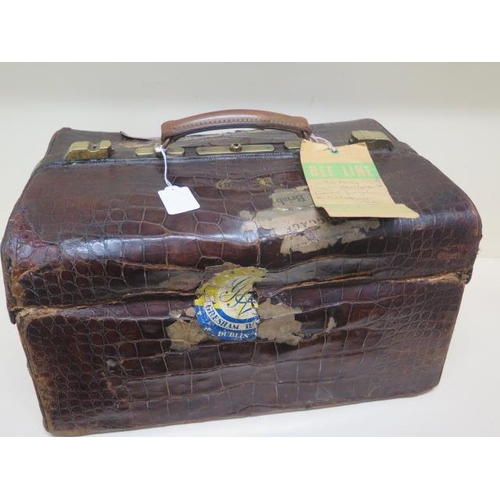 284 - An early 20th century crocodile travel case by Finnigan makers with a fitted interior including seve... 