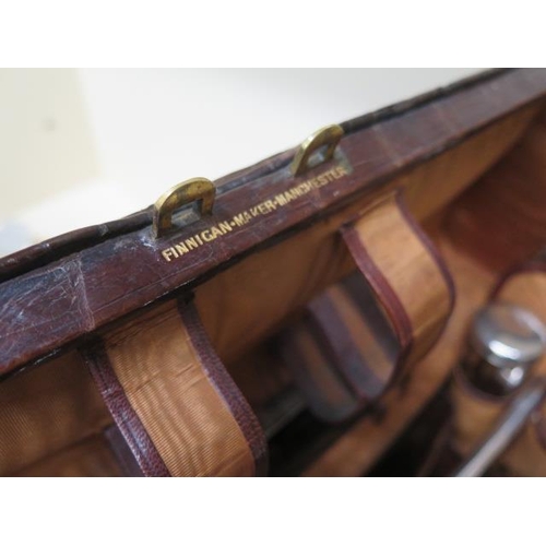 284 - An early 20th century crocodile travel case by Finnigan makers with a fitted interior including seve... 