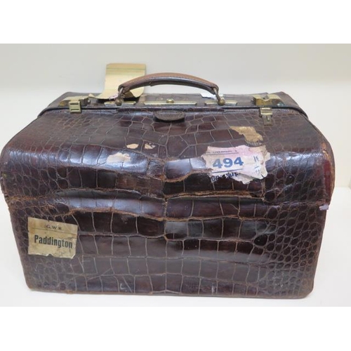 284 - An early 20th century crocodile travel case by Finnigan makers with a fitted interior including seve... 