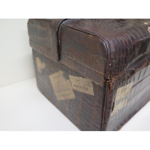 284 - An early 20th century crocodile travel case by Finnigan makers with a fitted interior including seve... 