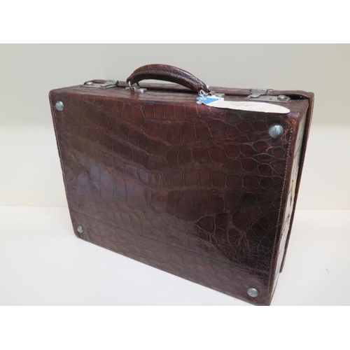 285 - An early 20th century crocodile travel suitcase - Width 45cm x 16cm x 35cm - wear consistent with ag... 