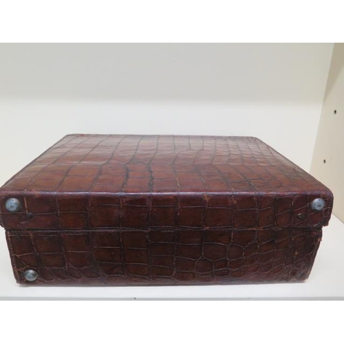 285 - An early 20th century crocodile travel suitcase - Width 45cm x 16cm x 35cm - wear consistent with ag... 