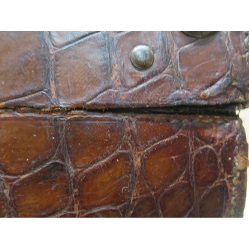 285 - An early 20th century crocodile travel suitcase - Width 45cm x 16cm x 35cm - wear consistent with ag... 