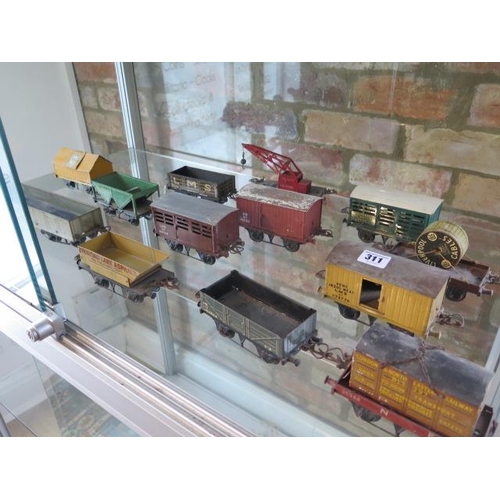 311 - A collection of 26 Hornby and other tinplate and wood rolling stock - original paint, some wear