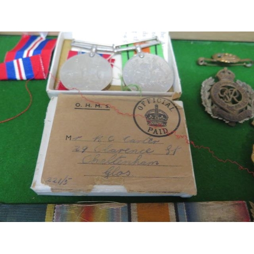 323 - A collection of WWI and WWII medals - a group of three unnamed WWII medals, a pair of WWII unnamed m... 