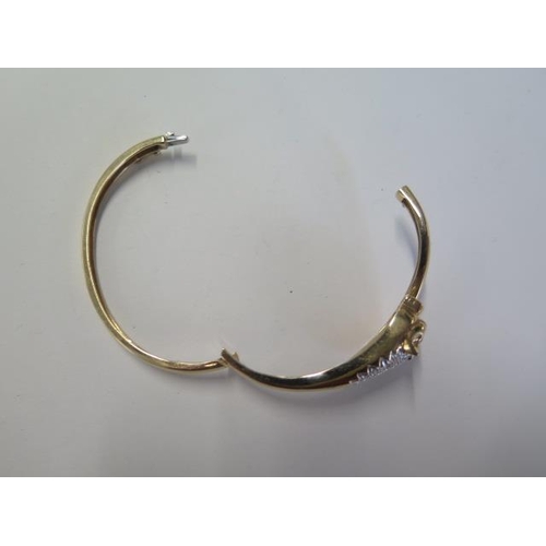 33 - A 9ct yellow gold leopards head hinged bangle set with small diamonds - 6.5cm x 6cm external - appro... 