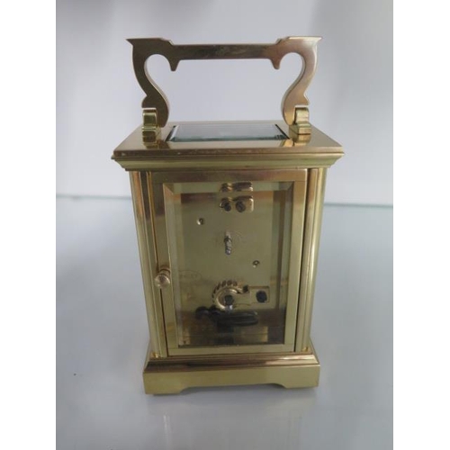 A brass carriage clock the dial signed Henley Height 15cm with handle