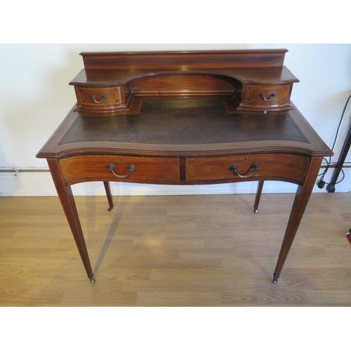 478 - An Edwardian mahogany two drawer ladies writing desk with leather top and galleried back with shelve... 