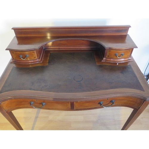 478 - An Edwardian mahogany two drawer ladies writing desk with leather top and galleried back with shelve... 