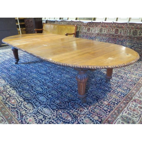 482 - A large oak dining D end table with an adapted later underframe standing on turned reeded legs with ... 