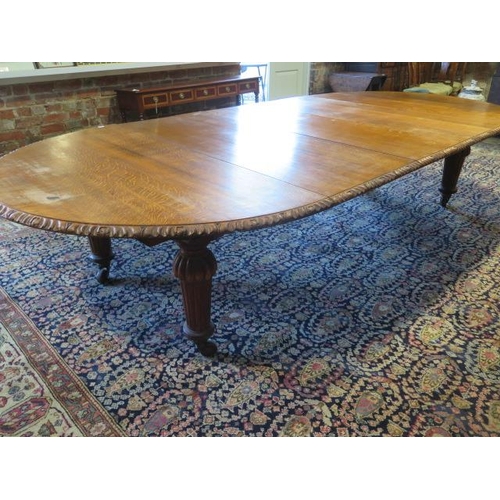 482 - A large oak dining D end table with an adapted later underframe standing on turned reeded legs with ... 