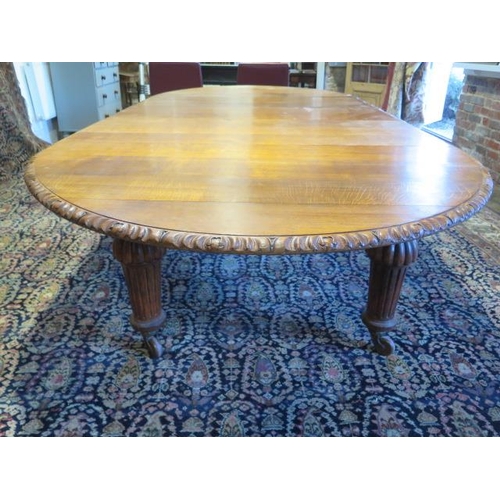 482 - A large oak dining D end table with an adapted later underframe standing on turned reeded legs with ... 