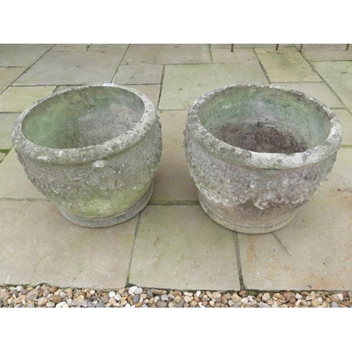 499 - A pair of vintage cast stone planters with scrolled flower decorations - Diameter 43cm x Height 32cm